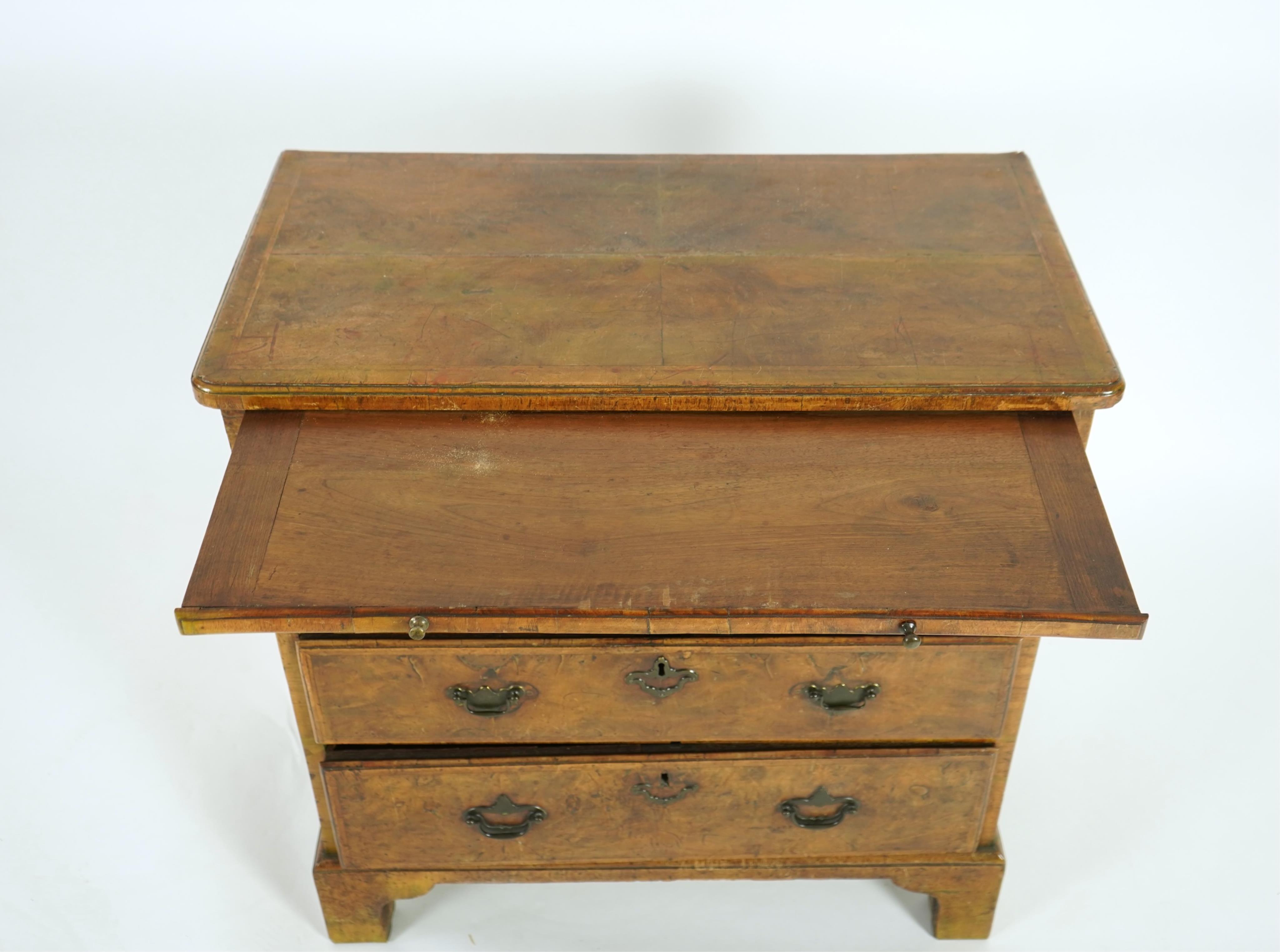 A small early 18th century and later cross and feather banded walnut veneered chest